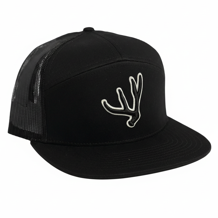 Black colored 7 panel trucker hat with matching puff embroidered mule deer antler